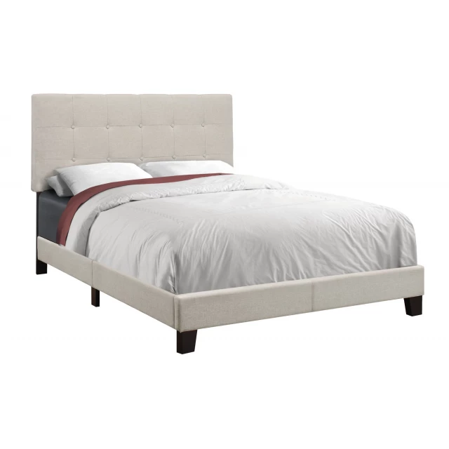 full beige linen bed in a well-lit bedroom setting