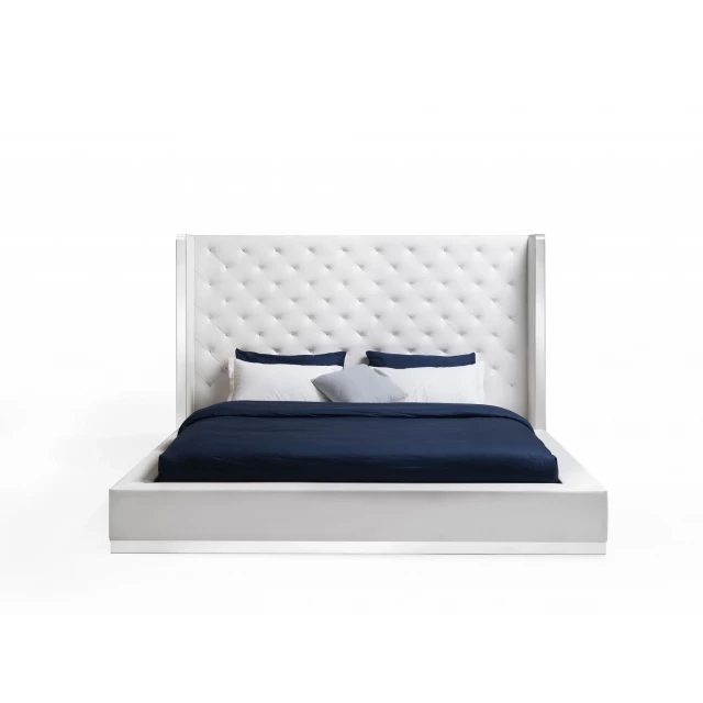 White faux leather king-sized bed in modern bedroom decor