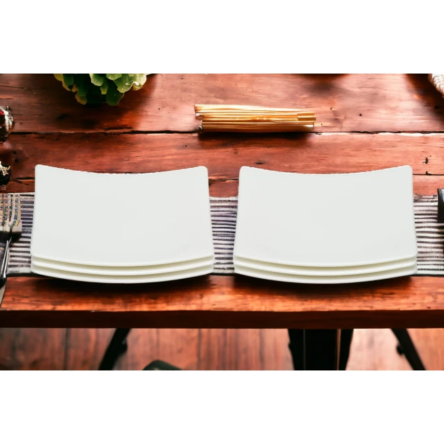 Bone china service for six with bread and butter plates on hardwood table