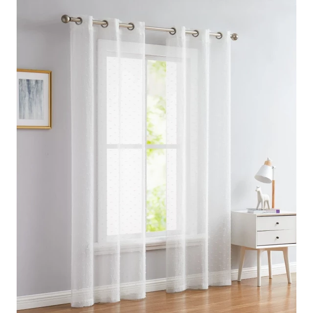 White sprinkled embellishment window curtain panel in interior design setting with wood flooring