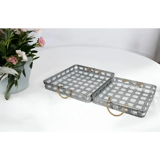 rectangular metal handmade trays with rope handles on table with flowers and plants