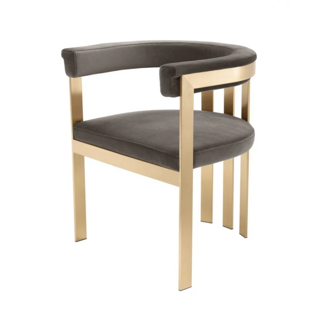Grey velvet gold arm chair with wood accents in an outdoor setting