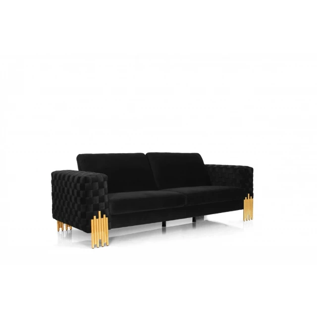 Black velvet gold sofa with comfortable cushioning and wooden accents in a living room setting