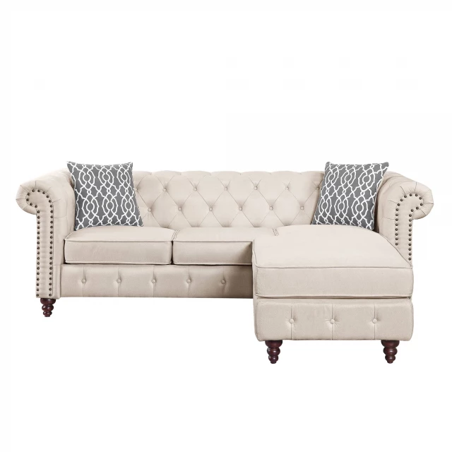 Beige linen L-shaped sofa chaise with wood accents in an interior design setting