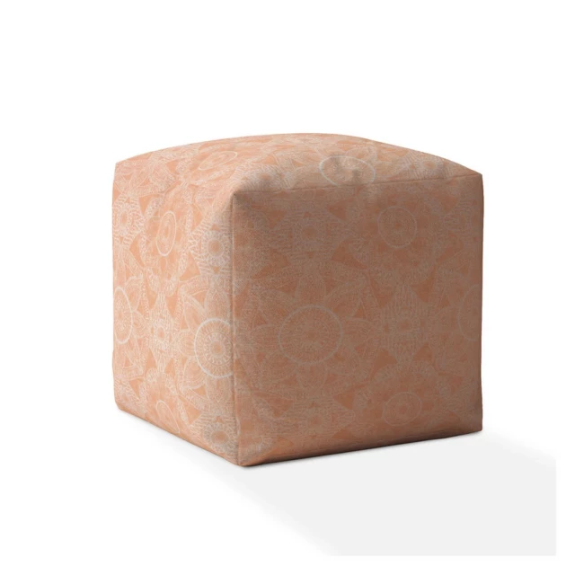 Orange cotton floral pouf cover on wooden background with brick details