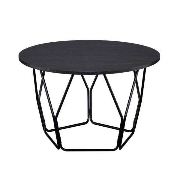 Black espresso round coffee table with tableware and drinkware on top in an outdoor setting