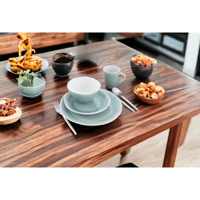 Sage sixteen ceramic service for four dinnerware set with plates cups and tableware on table