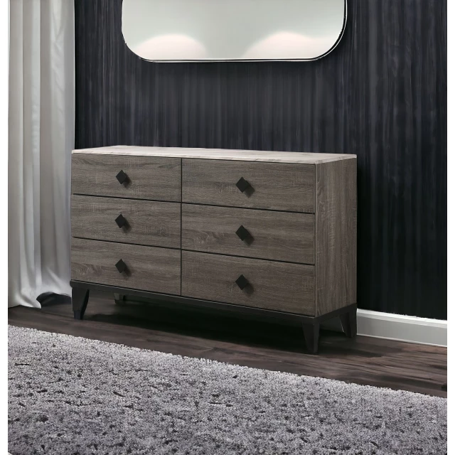 Rustic gray oak six drawer dresser in a minimalist bedroom setting