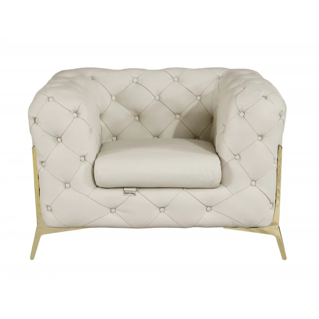 Glam beige gold tufted leather armchair with comfortable armrests perfect for elegant home decor