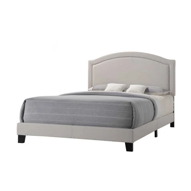 Standard bed with upholstered nailhead trim headboard in elegant bedroom decor