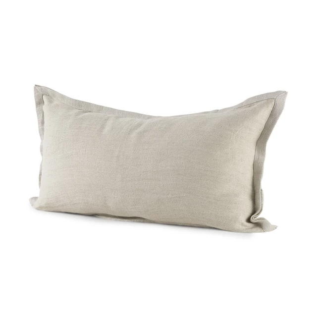 Beige cream bordered lumbar pillow cover on couch with throw pillow accessories