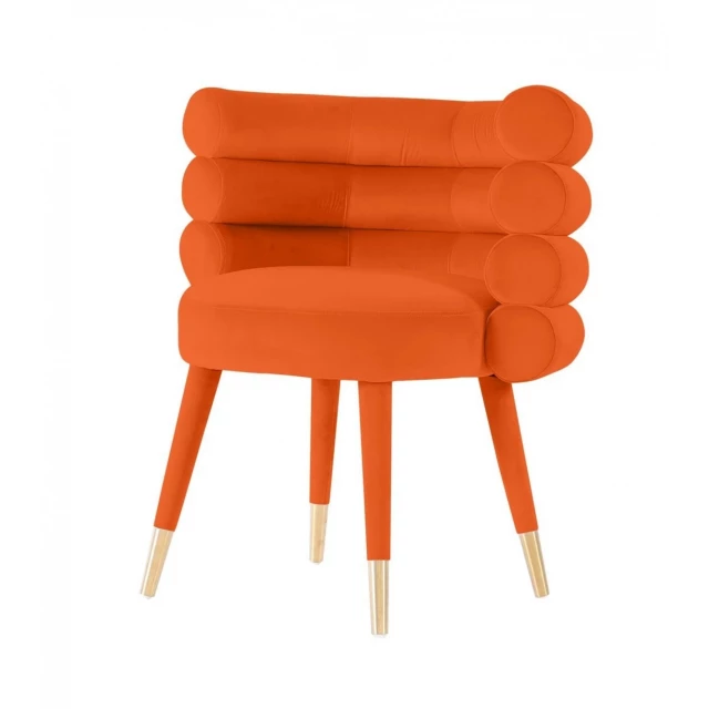 Orange velvet barrel chair in electric blue and peach colors with a fashion accessory vibe