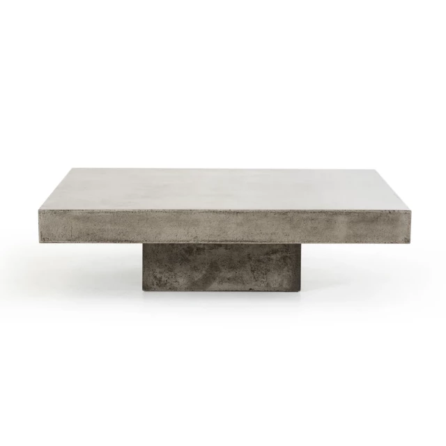 Gray concrete modern square coffee table with wood accents and plant on outdoor flooring