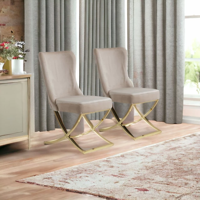 Gold upholstered microfiber dining side chairs with wood legs in an interior design setting featuring plants