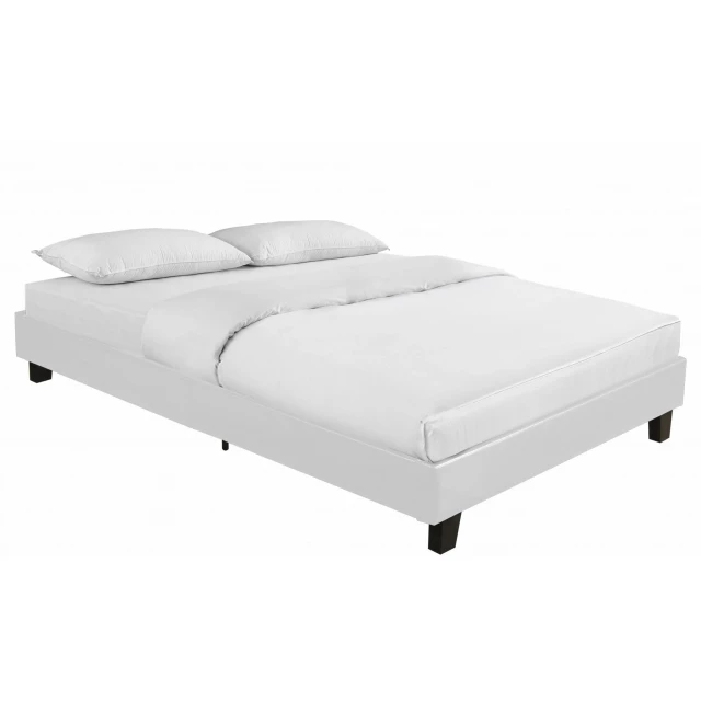 White platform queen bed in a modern bedroom setting