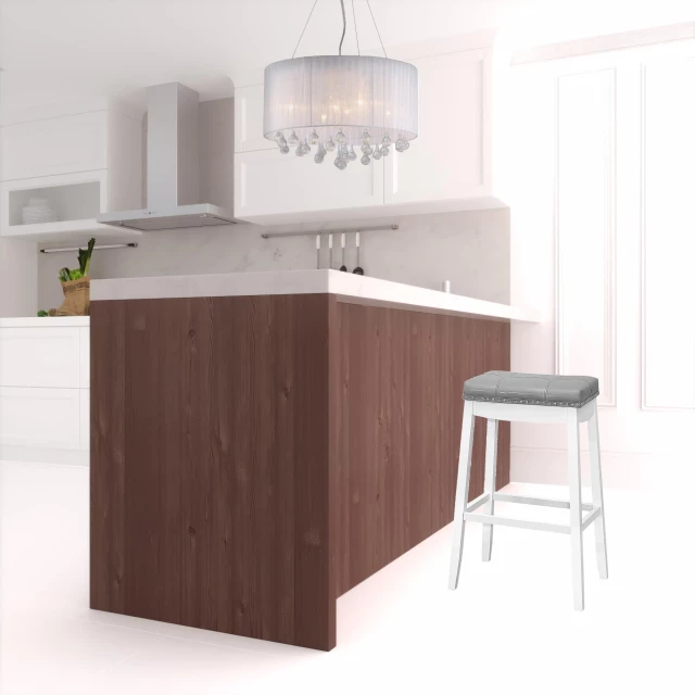 Wood backless bar height chairs in kitchen setting with cabinetry and wooden floor