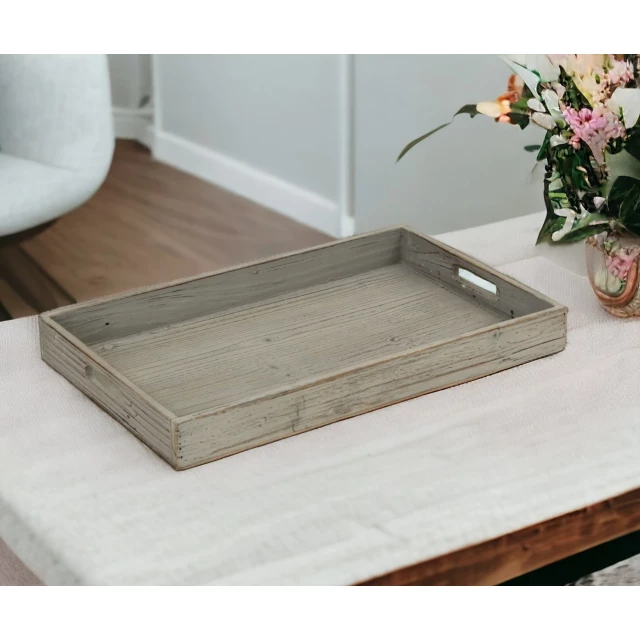 gray minimalist wooden tray with flowers and tableware on wooden floor