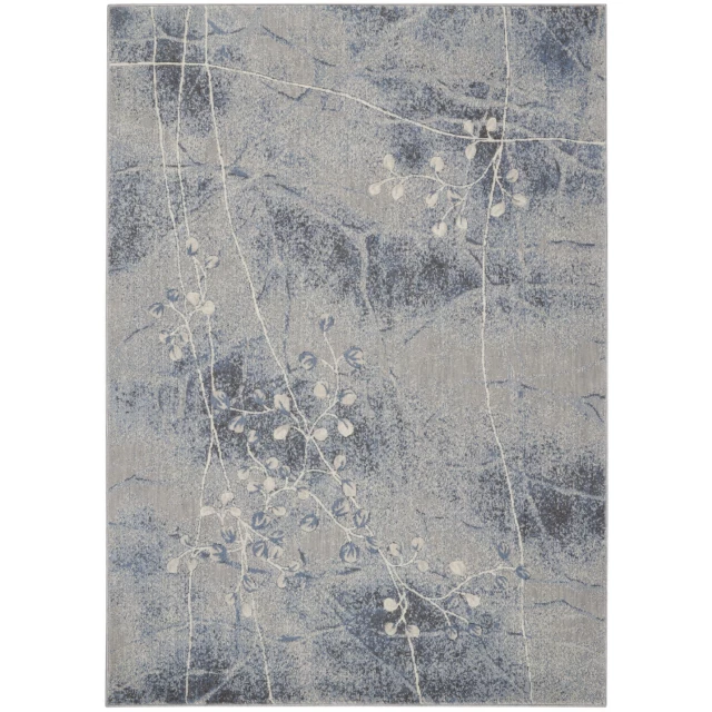 blue floral power loom area rug with plant and wood background