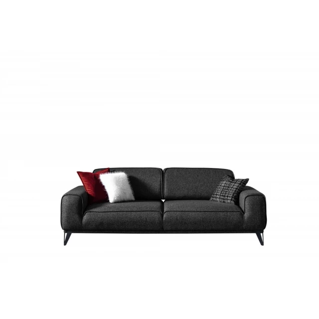 Dark gray linen sleeper sofa with pillows in a comfortable studio couch setup