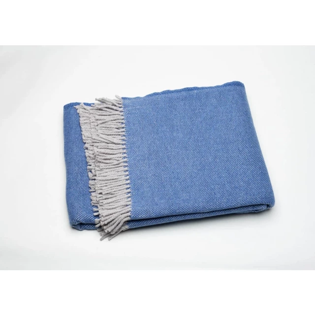 Blue mini dot fringed throw blanket made of natural wool material in electric blue denim fashion accessory