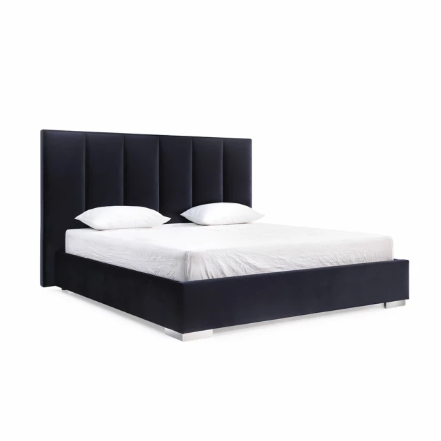 Queen tufted black upholstered velvet bed in elegant bedroom setting