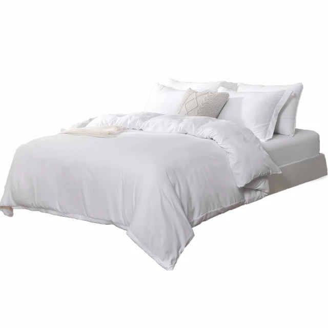 High thread count machine washable duvet cover on sofa with pillows and wooden accents