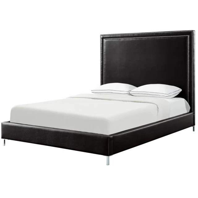 Upholstered faux leather bed with nailhead trim in a stylish bedroom setting