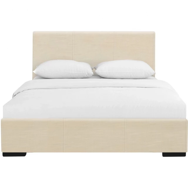 Beige upholstered king platform bed in a modern bedroom setting