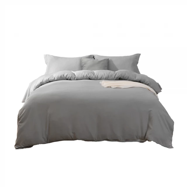 Grey thread count machine washable duvet cover on wood bed with pillows in bedroom furniture setting