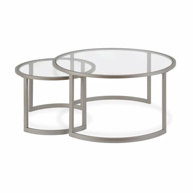 Glass and steel round nested coffee tables with metal accents in a furniture setting