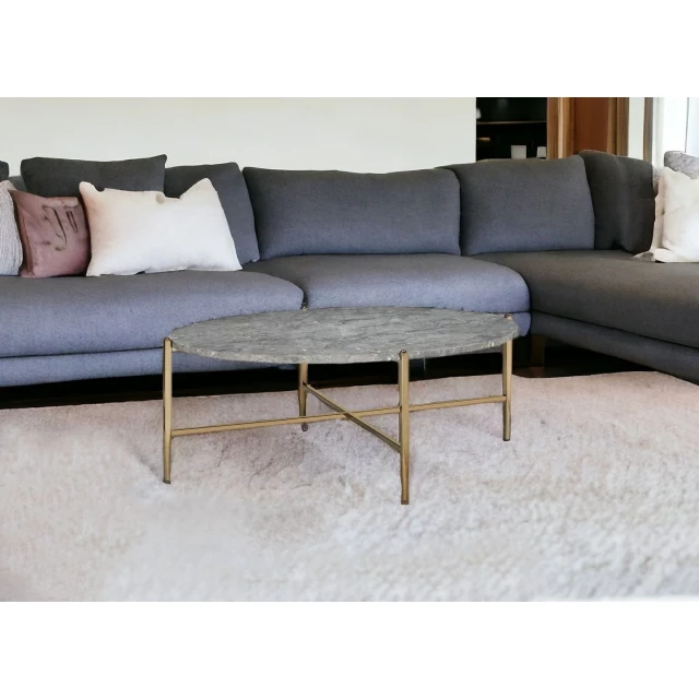 faux marble metal oval coffee table in a stylish interior with couch and sleek flooring