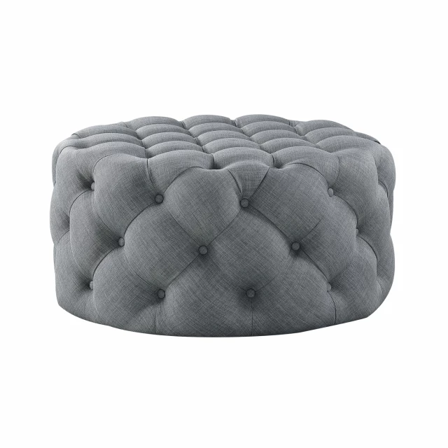 Black rolling tufted round cocktail ottoman with comfortable plush top and intricate pattern design