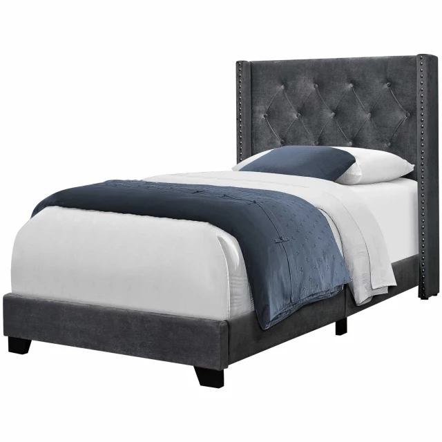 Grey velvet chrome trimmed twin bed in modern bedroom setting