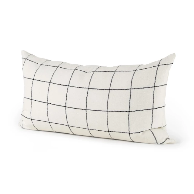 Black grid lumbar accent pillow cover on couch with metallic and fashion accessory elements