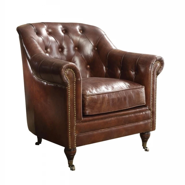Brown grain leather tufted chesterfield chair with wood armrests and natural material accents
