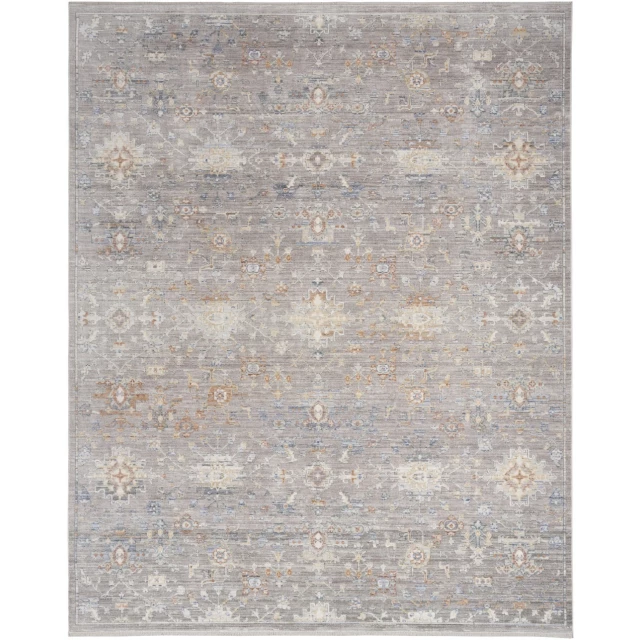 power loom distressed area rug with fringe in brown grey beige pattern on concrete surface