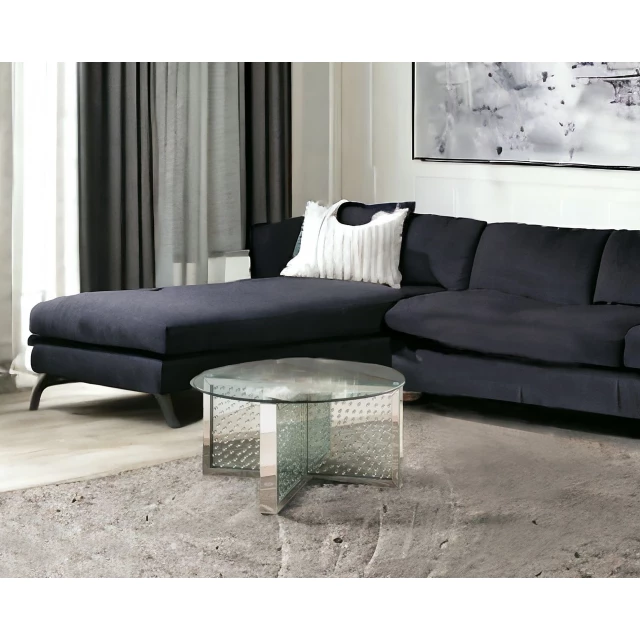 Silver glass round mirrored coffee table with wood accents and modern interior design elements