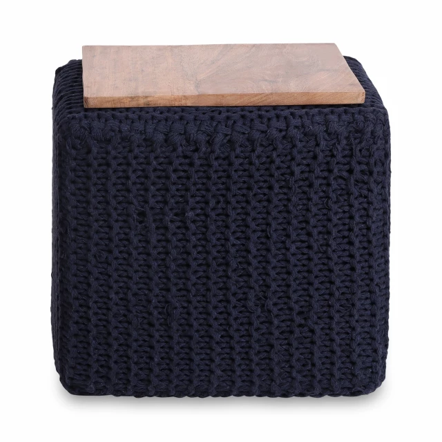 Blue cotton blend brown pouf ottoman in a cozy room setting with wood accents and plants
