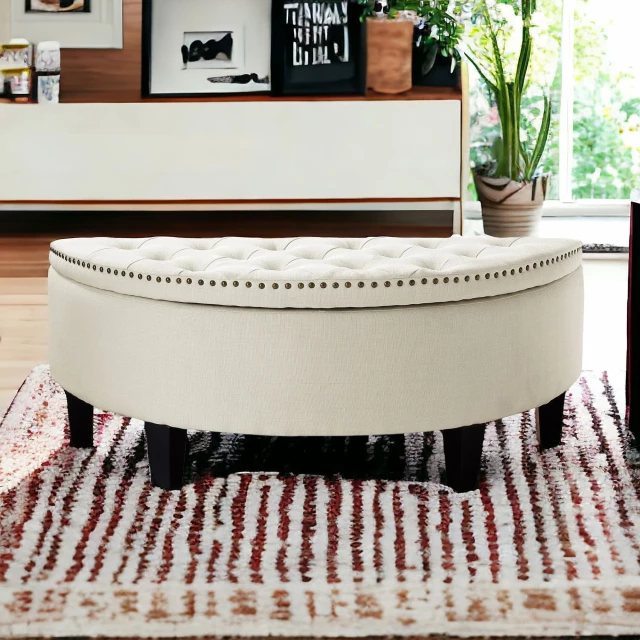 Linen black tufted half circle storage bench with interior design elements in a wood-floored room
