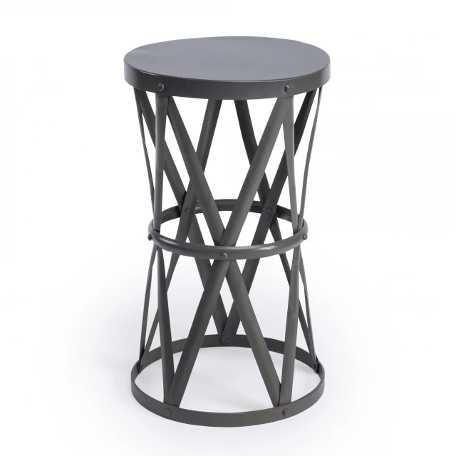 iron hourglass base round end table with glass top in a furnished setting