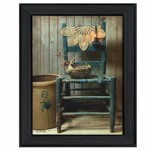 Black framed chair print wall art in a hardwood and window setting