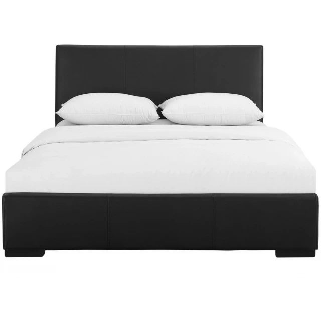 Black upholstered full platform bed in a modern bedroom setting