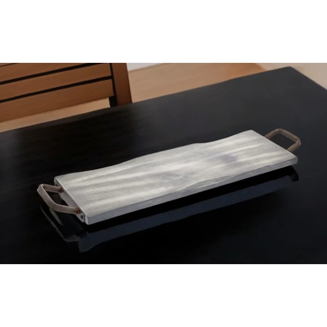 black wood metal serving tray with handles on hardwood surface