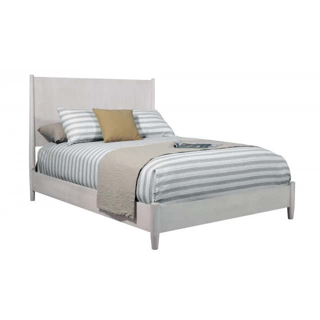 Gray solid manufactured wood king bed in a bedroom setting
