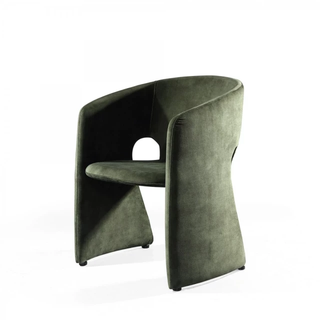 Green velvet barrel chair with metal and plastic accents in a contemporary design