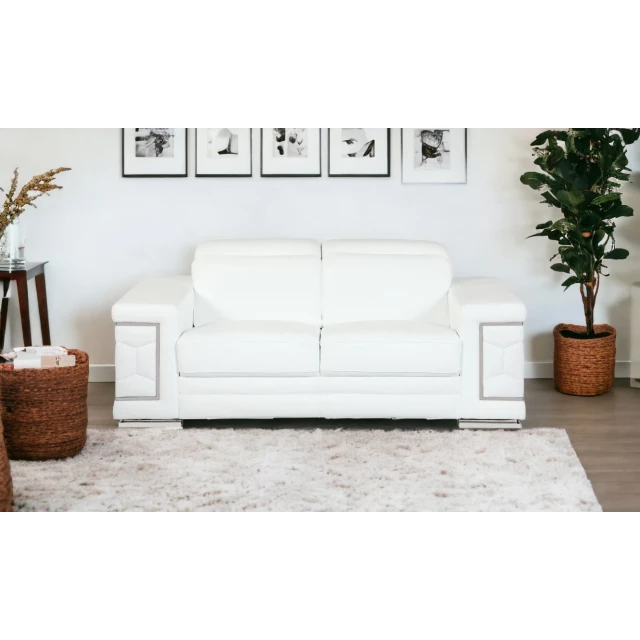 White silver Italian leather sofa in a stylish interior with grey wood accents