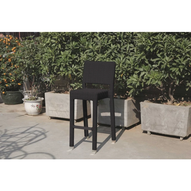 Black aluminum wicker bar table with houseplants and outdoor furniture setting