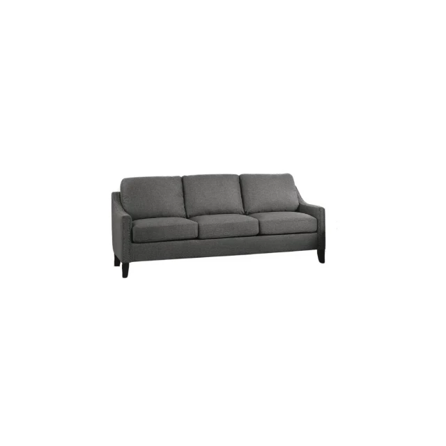 Gray linen black sofa with pillows and armrests in a comfortable studio couch design