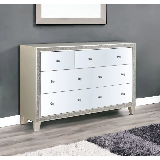 Wood mirrored multi-drawer triple dresser in a bedroom setting
