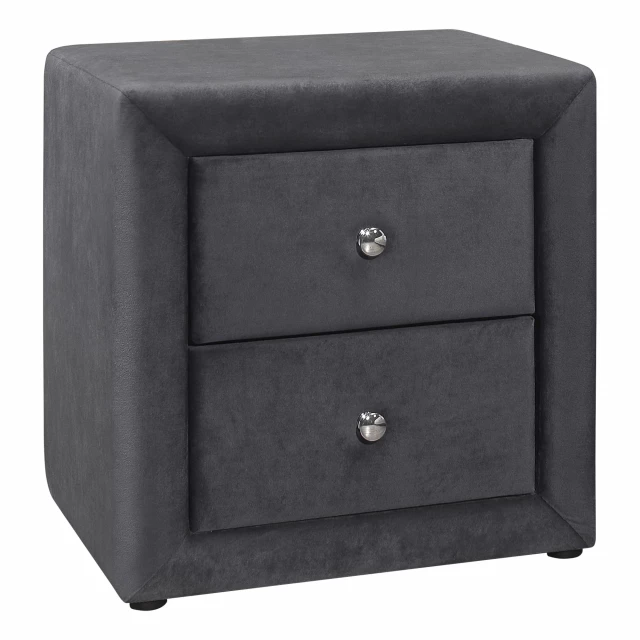 Dark gray velvet drawer nightstand with wood accents and plant decoration in a furniture setting